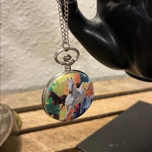 Artistic Pendant pocket watch with a galloping horse design on a silver chain